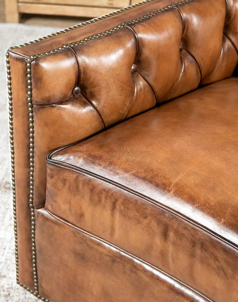 Close-up of the leather-wrapped armrest on the Oceanside Swivel Chair, showcasing its handcrafted quality.