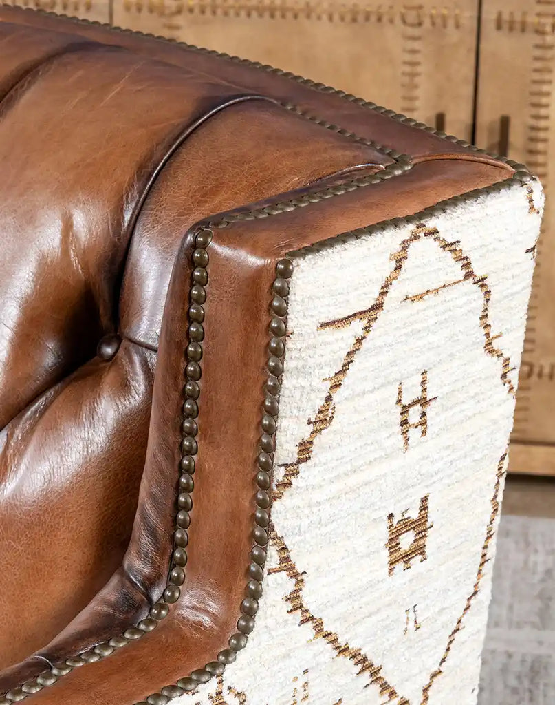 Close-up of the brass nail head accents on the Oceanside Swivel Chair, adding a touch of sophistication.