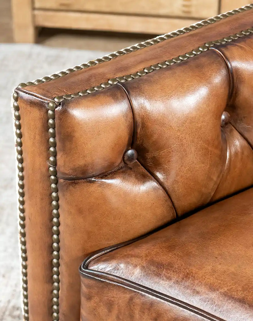 Close-up of the hand-burnished mocha-colored leather on the Oceanside Swivel Chair, showcasing its rich texture.