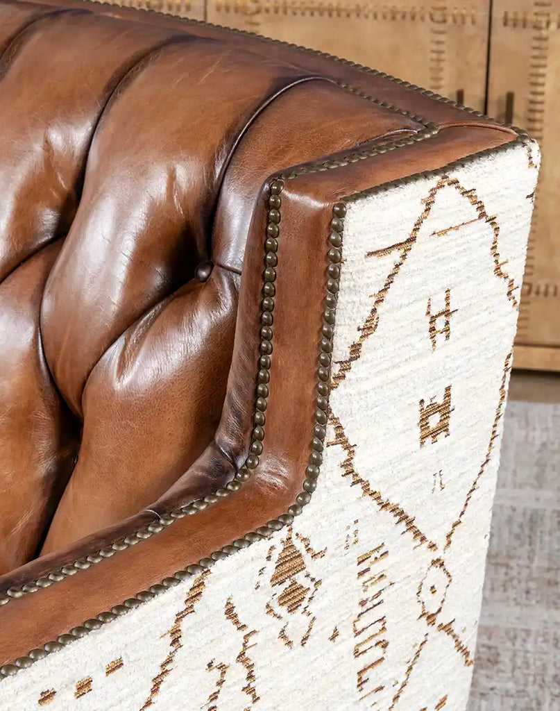 Detailed view of the tufted leather seat back on the Oceanside Swivel Chair, highlighting its luxurious design.