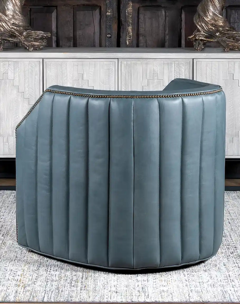 A rear view of the Olga Grey Swivel Chair, displaying its sleek barrel shape and detailed stitching.