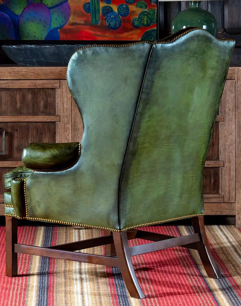 Back view of the Olive Green Wingback Chair highlighting its seamless leather finish and traditional craftsmanship.