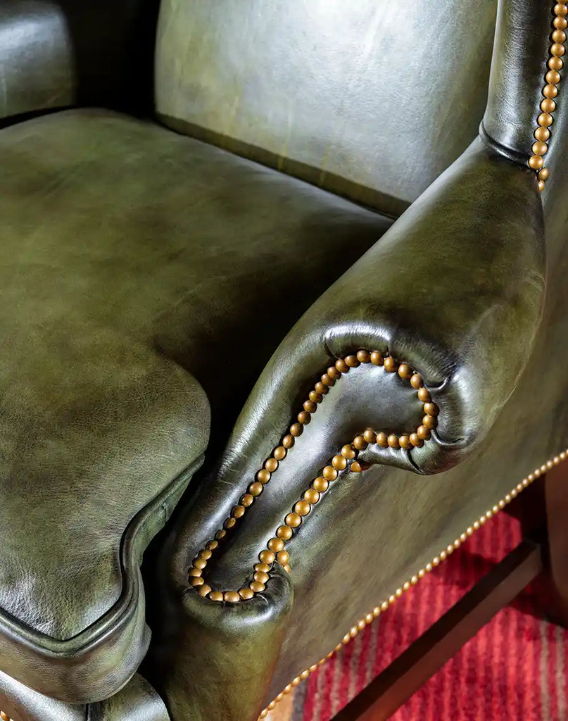 Smoothly curved armrests of the Olive Green Wingback Chair, designed for both style and comfort.