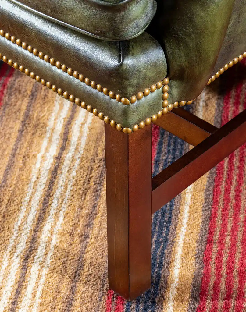 Close-up of the solid hardwood legs of the Olive Green Wingback Chair, emphasizing its durability and craftsmanship.