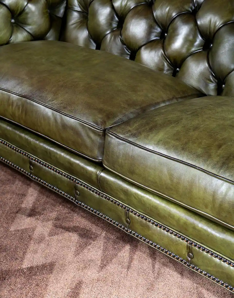 Detailed image showing the subtle variations in the olive full-grain leather of the Evergreen Chesterfield Sofa.