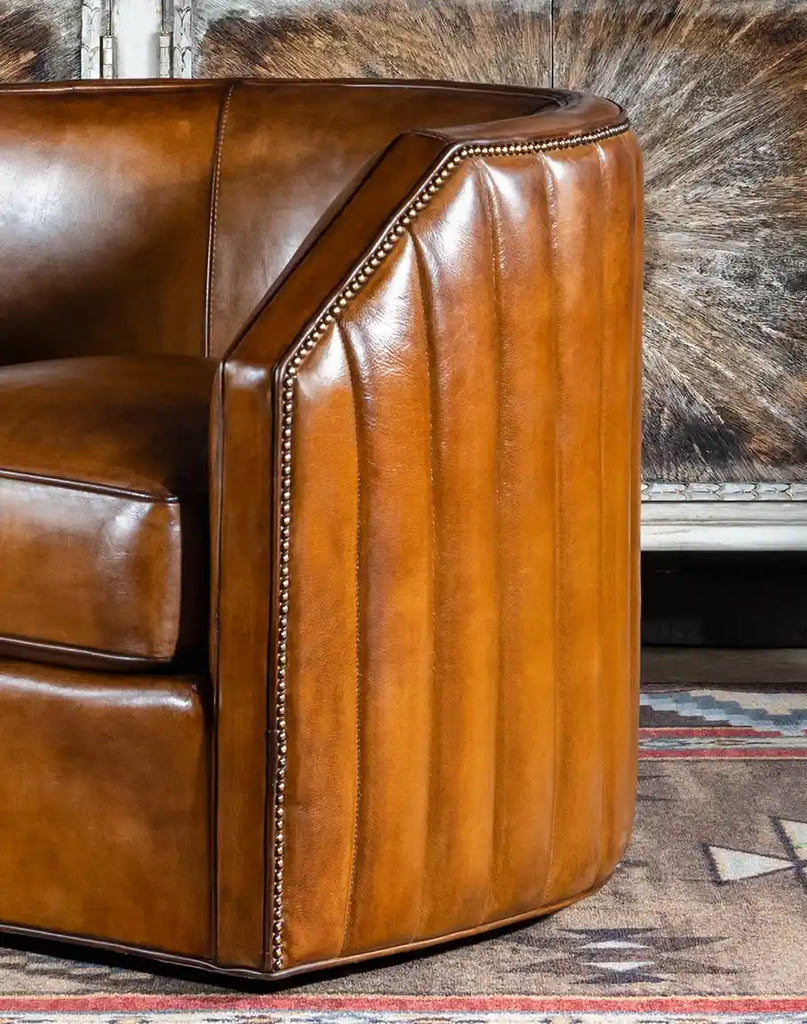 Detailed close-up of the Olivia Leather Swivel Chair's hand-burnished leather, emphasizing the texture and artisanal craftsmanship.