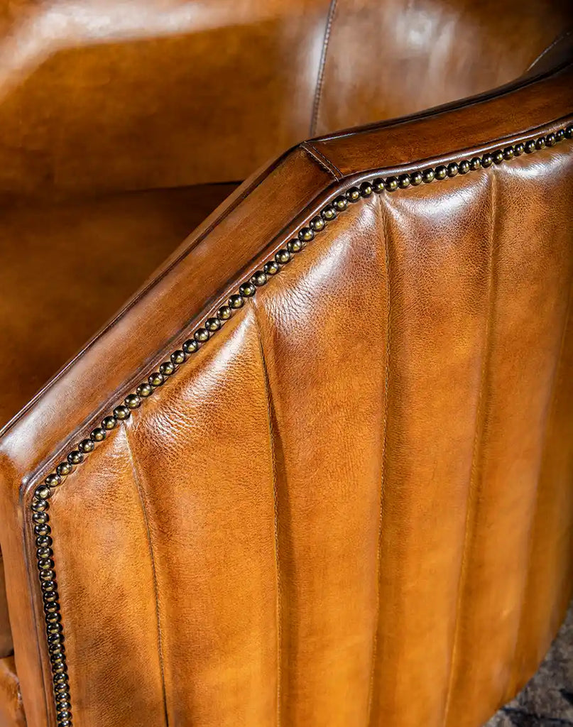 A detailed shot of the Olivia Leather Swivel Chair’s thick, full-grain leather hide, emphasizing its luxurious material quality.