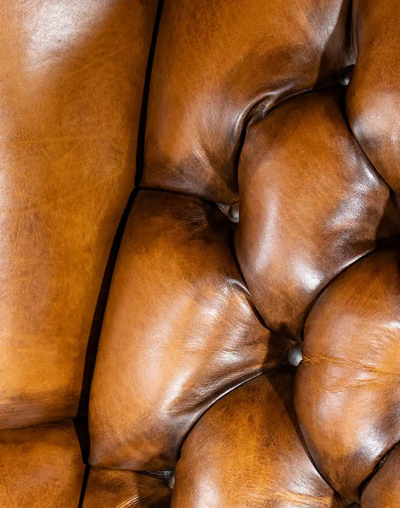 Detailed close-up of the tufted backrest on the Olivia Tufted Leather Chair, featuring premium hand-burnished leather.