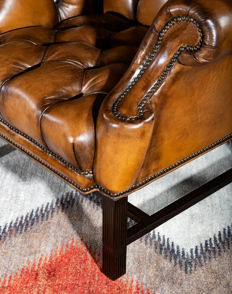 Elegantly crafted legs of the Olivia Tufted Leather Chair, featuring a durable hardwood construction with a polished finish.