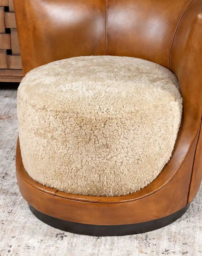 Detailed close-up showing the contrast between the plush shearling and the full-grain antiqued leather, emphasizing the chair's craftsmanship.