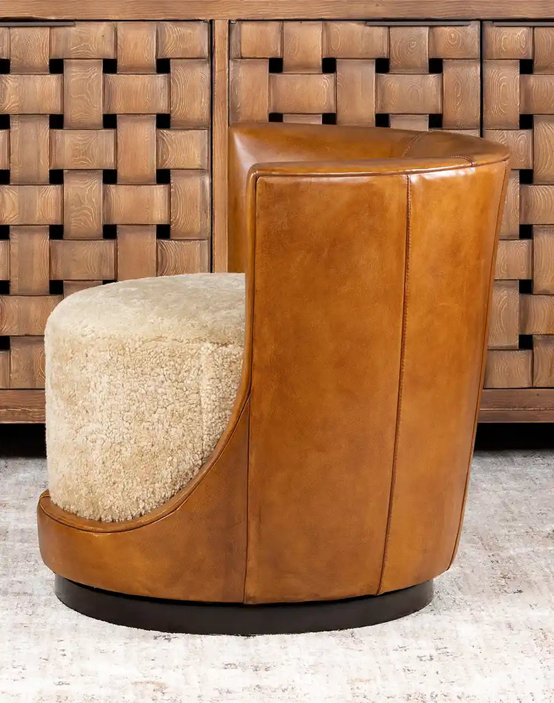 Side profile highlighting the chair's elegant curves, shearling-covered outer arms, and the rich texture of the antiqued leather.