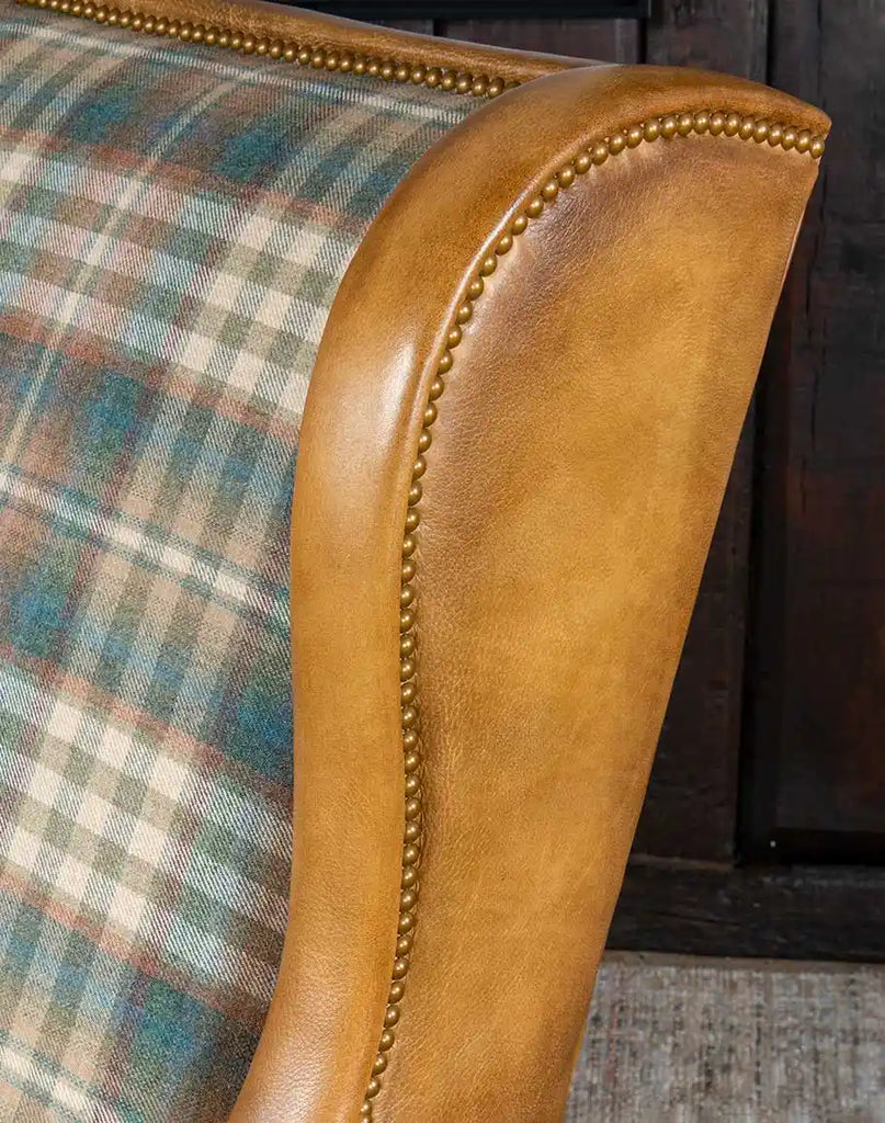 Detailed view of the brass nail tacks on the arms and wing panels of the Patterned Spruce Chair, adding a touch of sophistication.