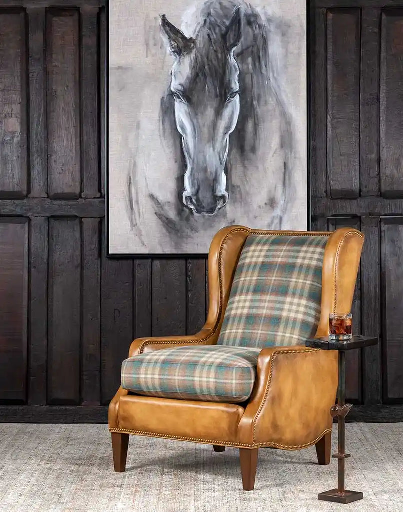 The Patterned Spruce Chair placed in a refined interior, exuding timeless elegance with its plaid wool, leather accents, and expert craftsmanship.