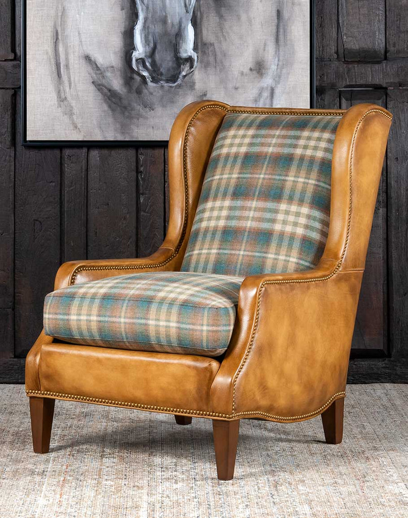 Patterned Spruce Chair showcasing its full-grain leather upholstery, plaid wool seat and back, and elegant wingback design.