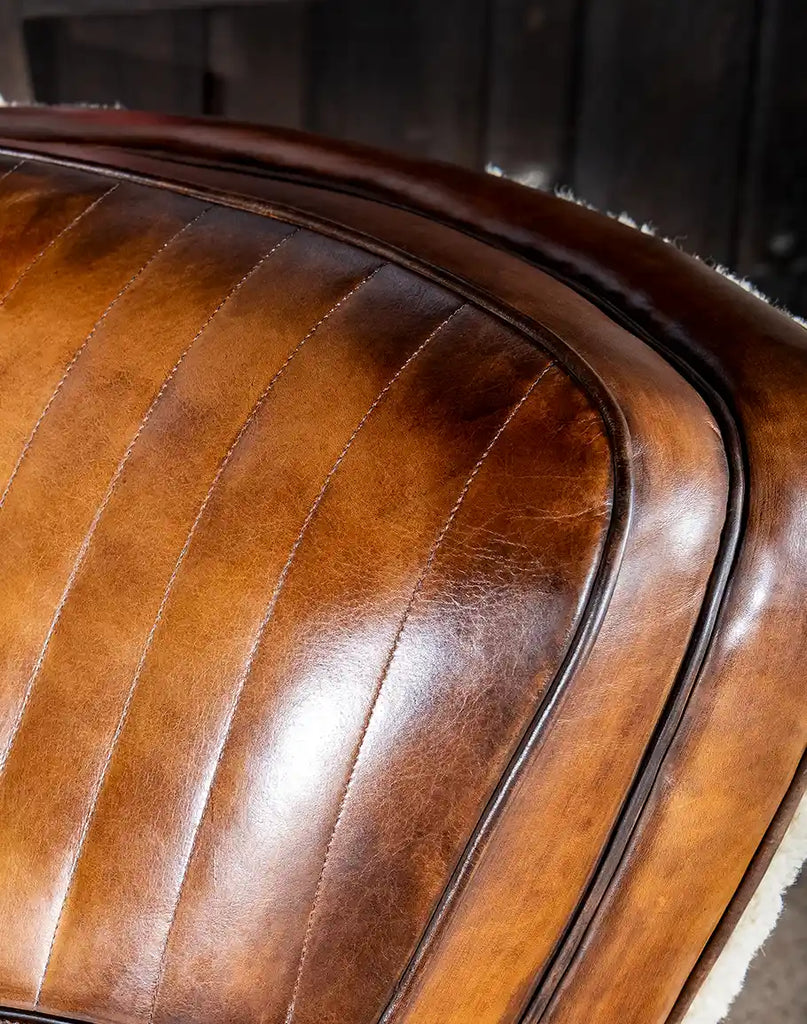 Detailed close-up of the rich leather grain and hand-finishing that enhances the chair’s luxurious appeal.