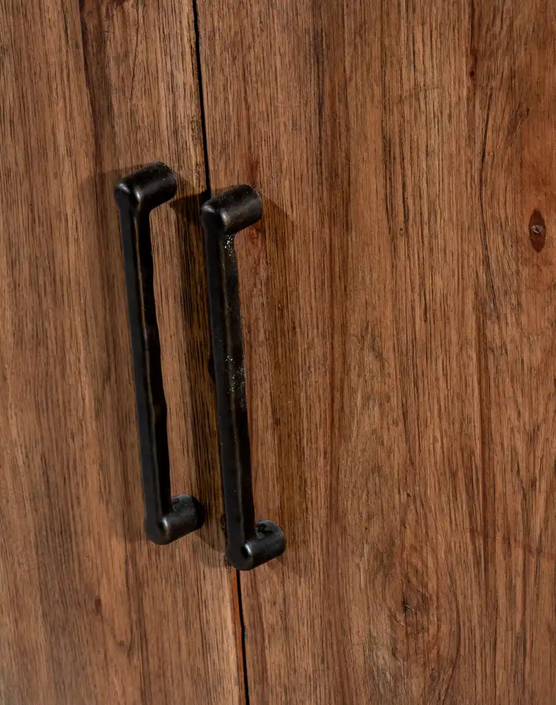 A close-up of the dark brushed bronze bar pulls on the doors of the Plano TX Media Console, emphasizing its refined hardware details.