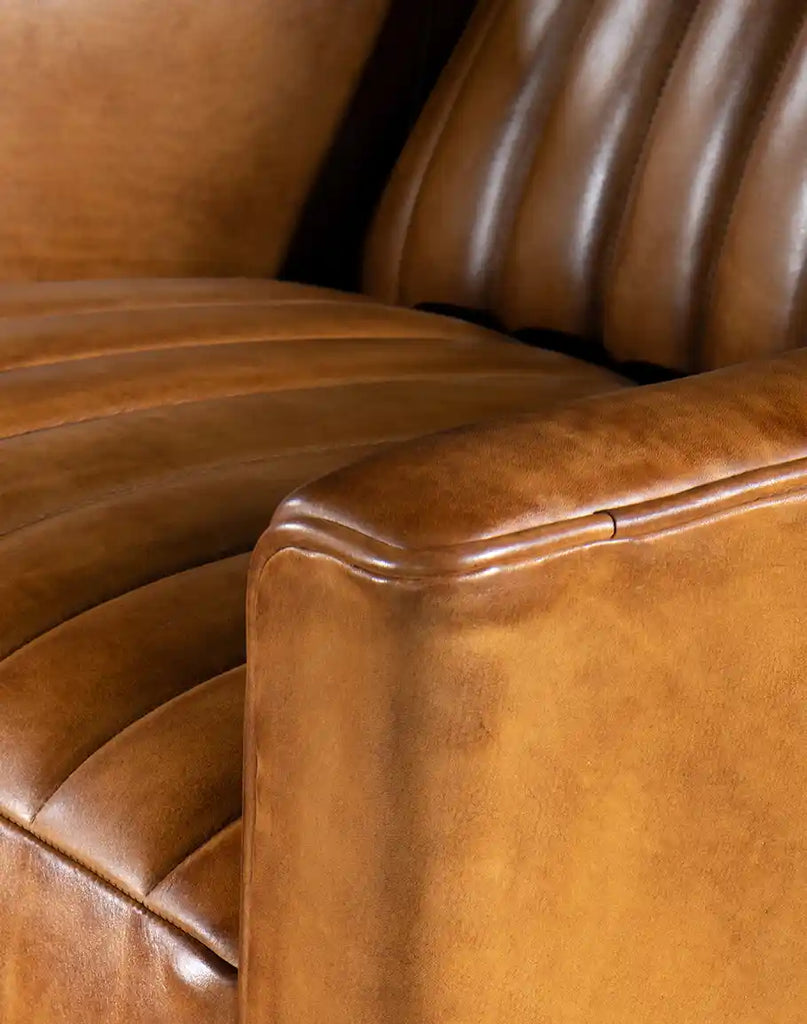 Close-up of the straight armrest, showing the refined saddle leather upholstery and meticulous stitching.