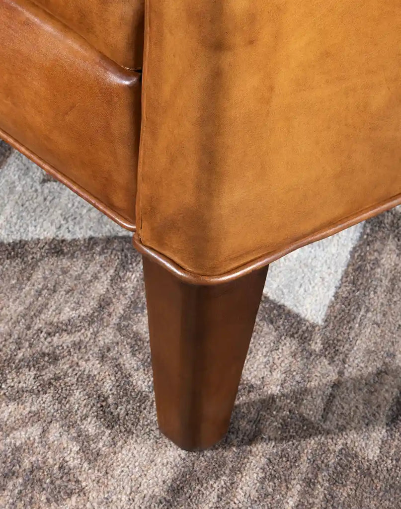 A detailed shot of the recliner’s tapered legs, adding a modern rustic touch to its sophisticated design.