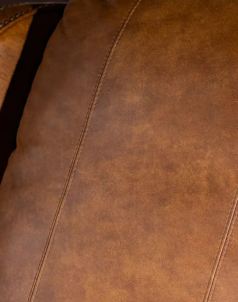 Close-up of the top-grain leather and hand-distressed finish on the Rancher Brindle Recliner.