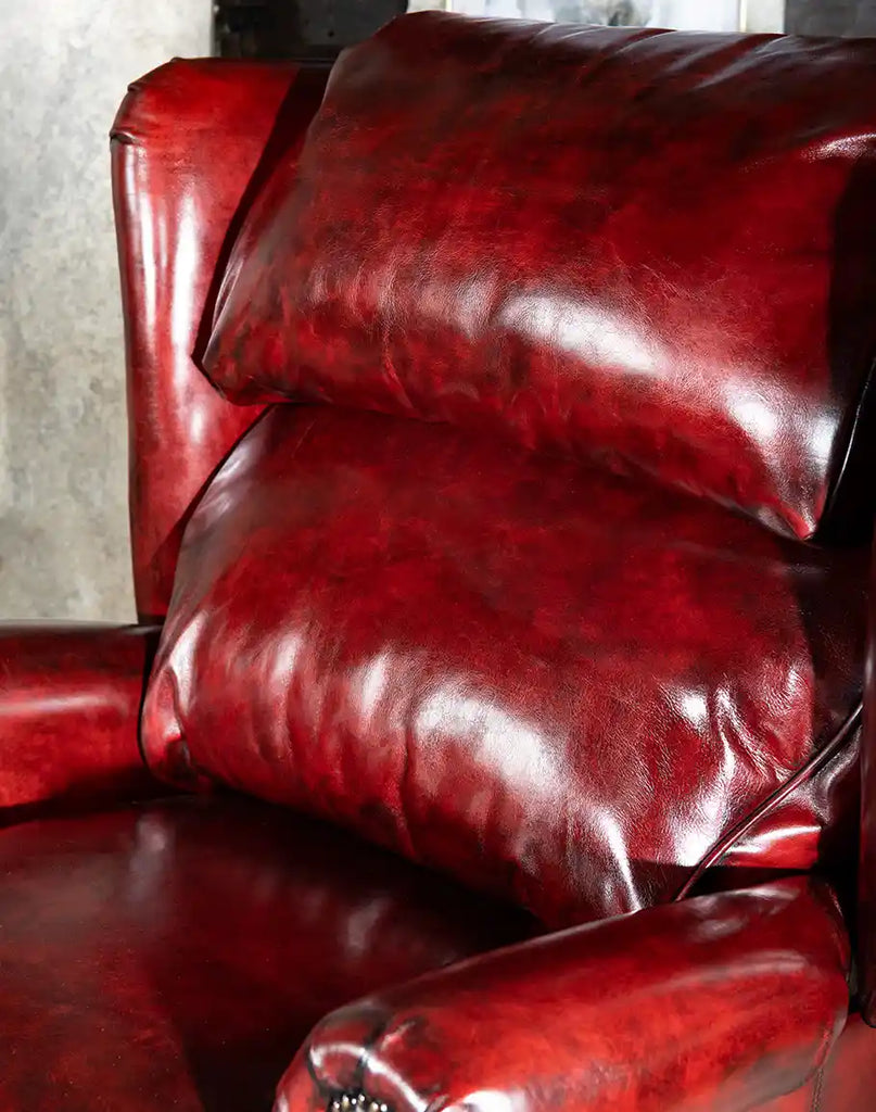 Detailed view of the Raspberry Leather Recliner's headrest, illustrating the supportive bustle back design for enhanced comfort.