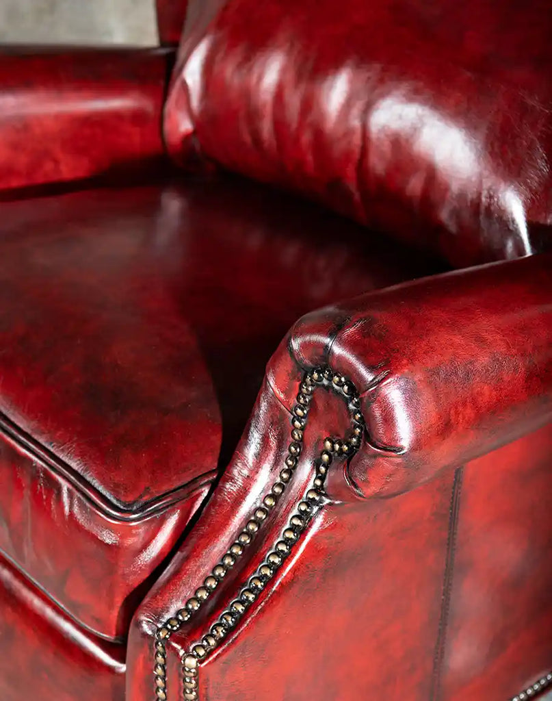 Detailed view of the Raspberry Leather Recliner's seat cushion, emphasizing the high-density foam and luxurious leather texture.