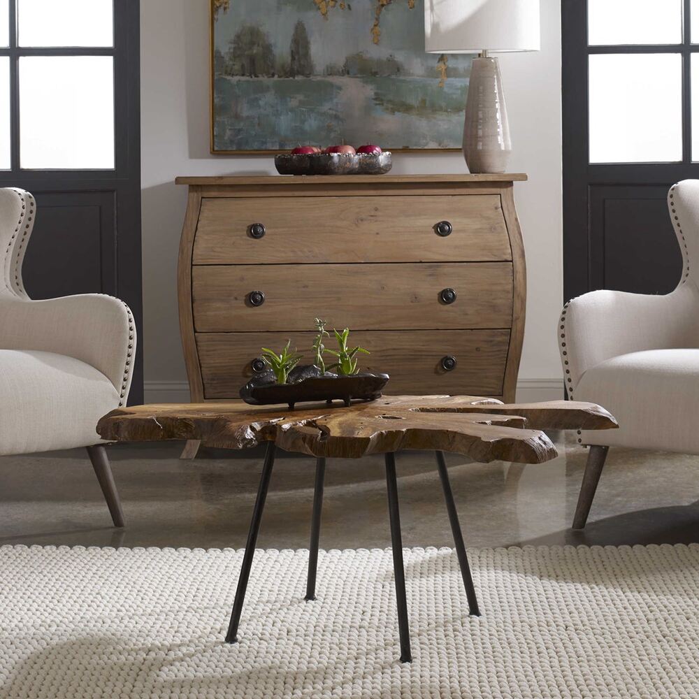 Ravi coffee table featuring a natural teak wood cross-section top with a light honey glaze, supported by aged black iron legs.