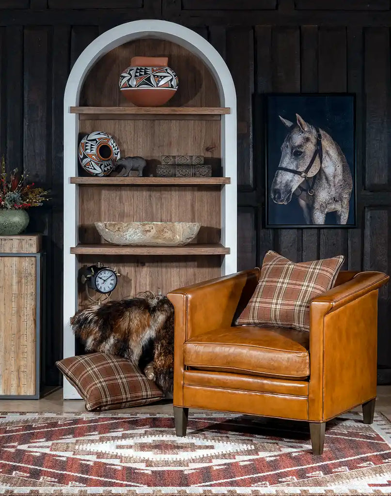 The Reno Club Chair positioned in a warm and inviting living space, paired with a rustic side table and soft lighting.