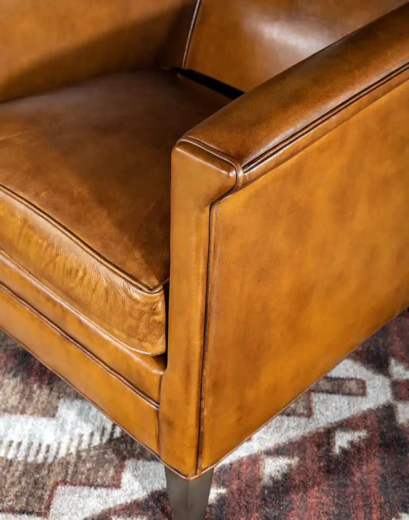 A detailed close-up of the premium full-grain leather on the Reno Club Chair, showcasing its natural texture and hand-burnished details.