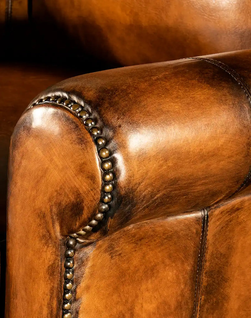 Close-up view of the intricate studded accents on the armrests of the Richard King Recliner.