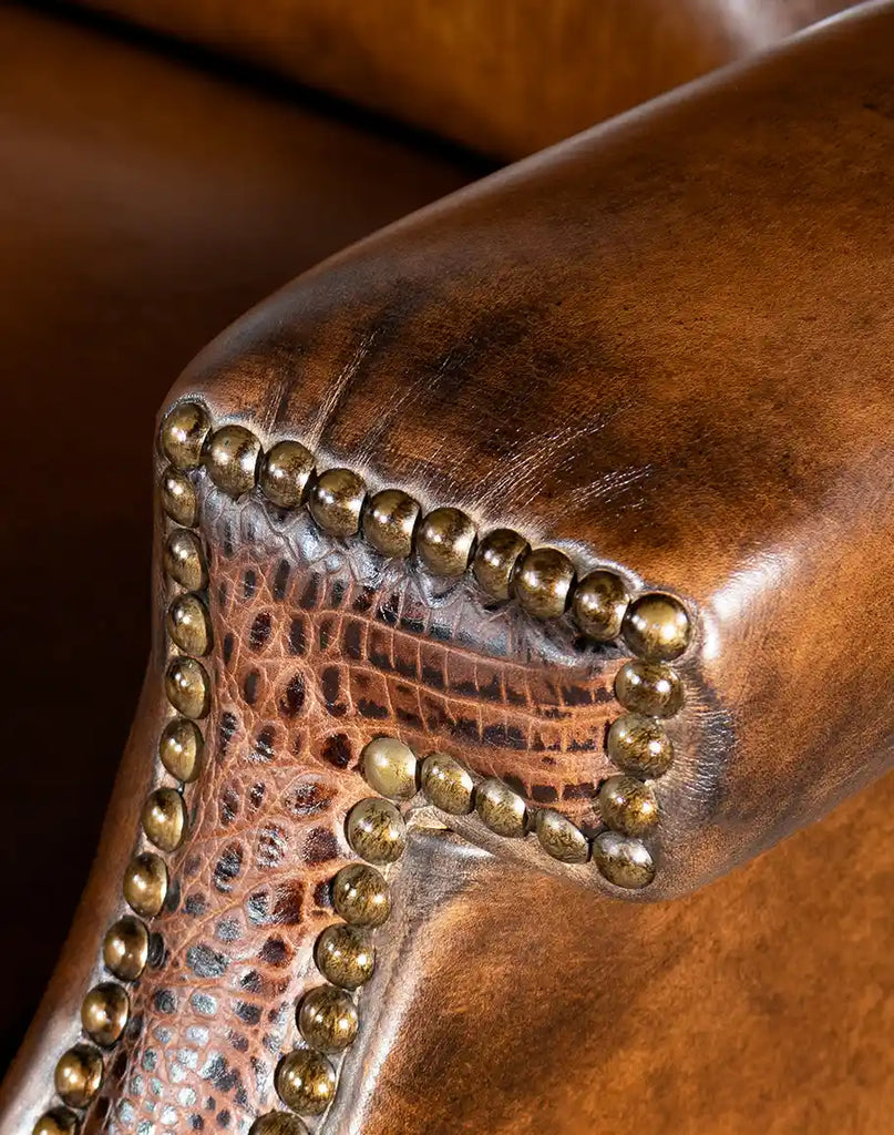 A detailed view of the brass nail tack trim, enhancing the recliner’s elegant and rustic aesthetic.