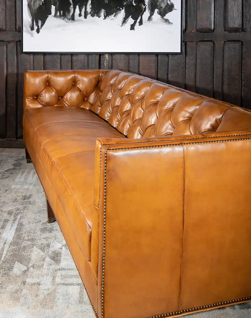 Angled shot of the Rochfort Chesterfield Sofa highlighting its straight arms, brass nailhead trim, and elegant silhouette.