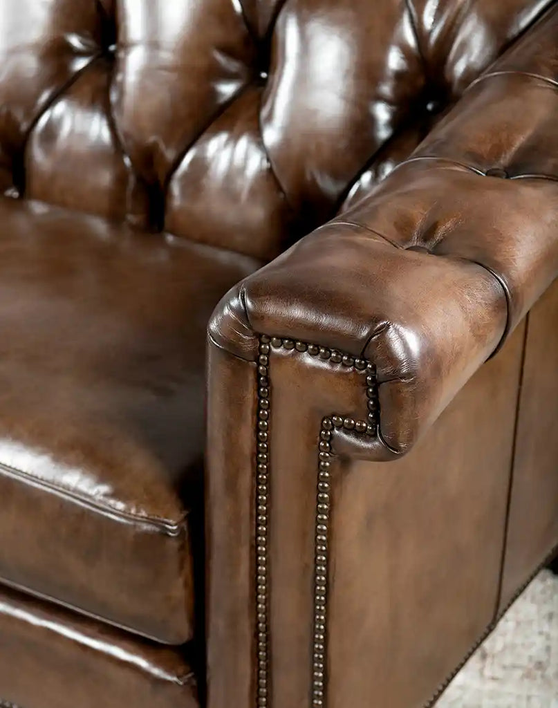 Close-up of the rolled armrest on the Rockwood Smoked Chesterfield Sofa, showcasing button tufting and leather welting.