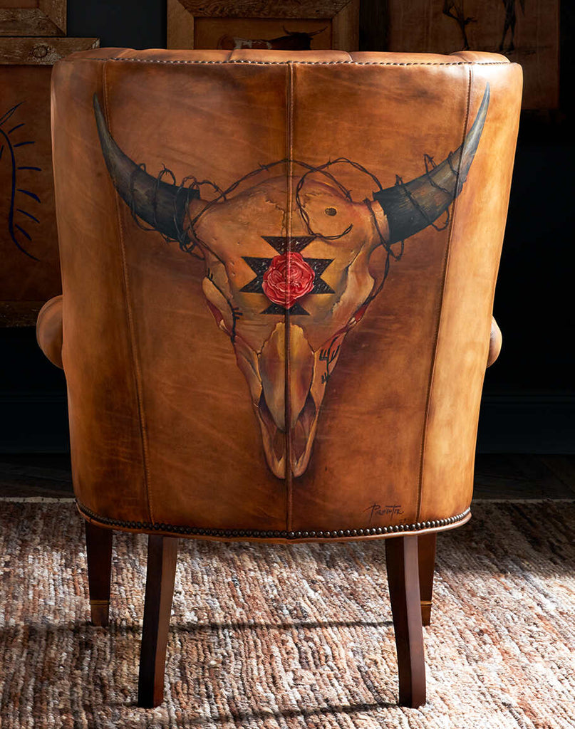 Rose Horns Tufted Leather Chair showcasing the bold bison skull hand-painted with cave petroglyphs and tufted leather design.