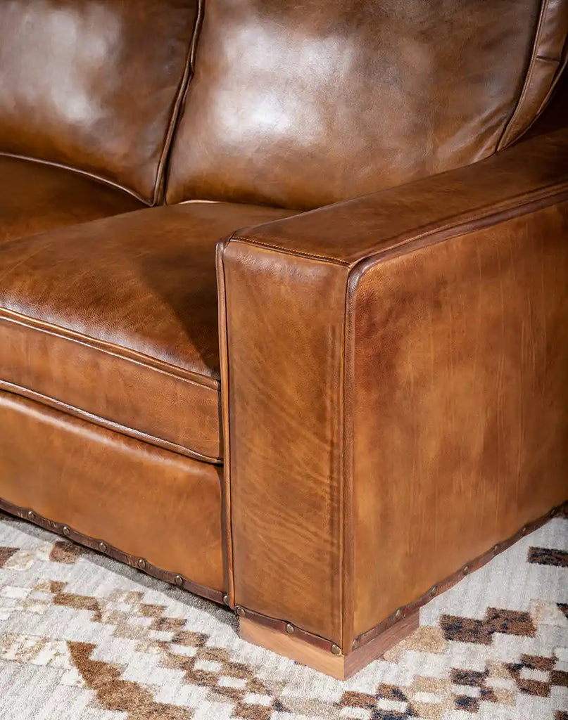 Close-up of the kiln-dried hardwood frame of the Ruby Cognac Leather Sofa, built for long-lasting durability.