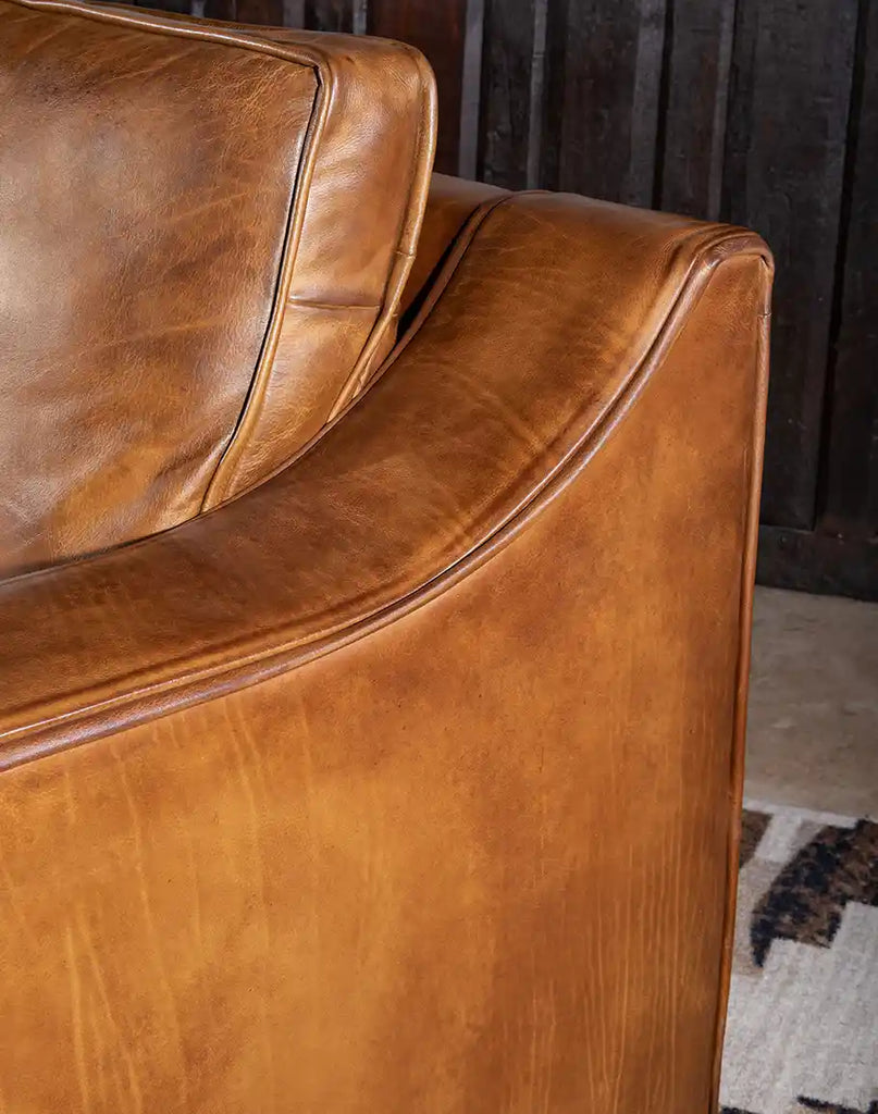 Close-up of the Ruby Cognac Leather Sofa's hand-burnished leather, showcasing its luxurious texture and craftsmanship.