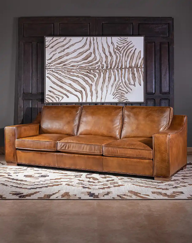 Side view of the Ruby Cognac Leather Sofa highlighting the solid black walnut block feet and tailored leather finish.