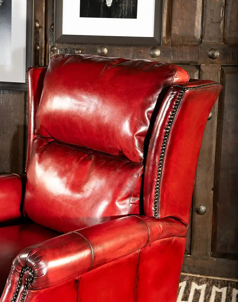 A detailed view of the Ruby Red Leather Recliner's rich red hand-burnished leather, emphasizing its texture and artisanal quality.