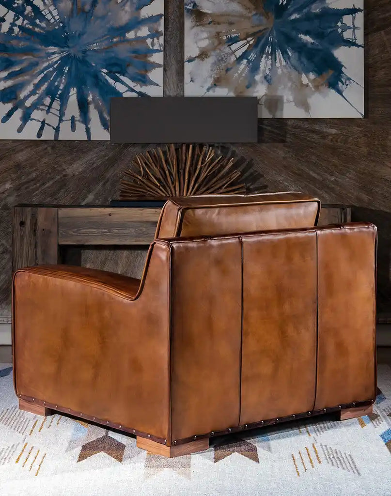 Back view of the Rusty Leather Chair displaying refined detailing and the elegant silhouette that complements its handcrafted appeal.