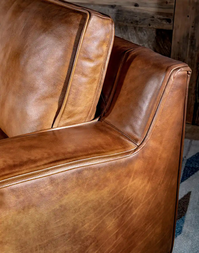 Detailed close-up of the exquisite hand-burnished leather, emphasizing the superior texture and meticulous artisanal finish on the Rusty Leather Chair.