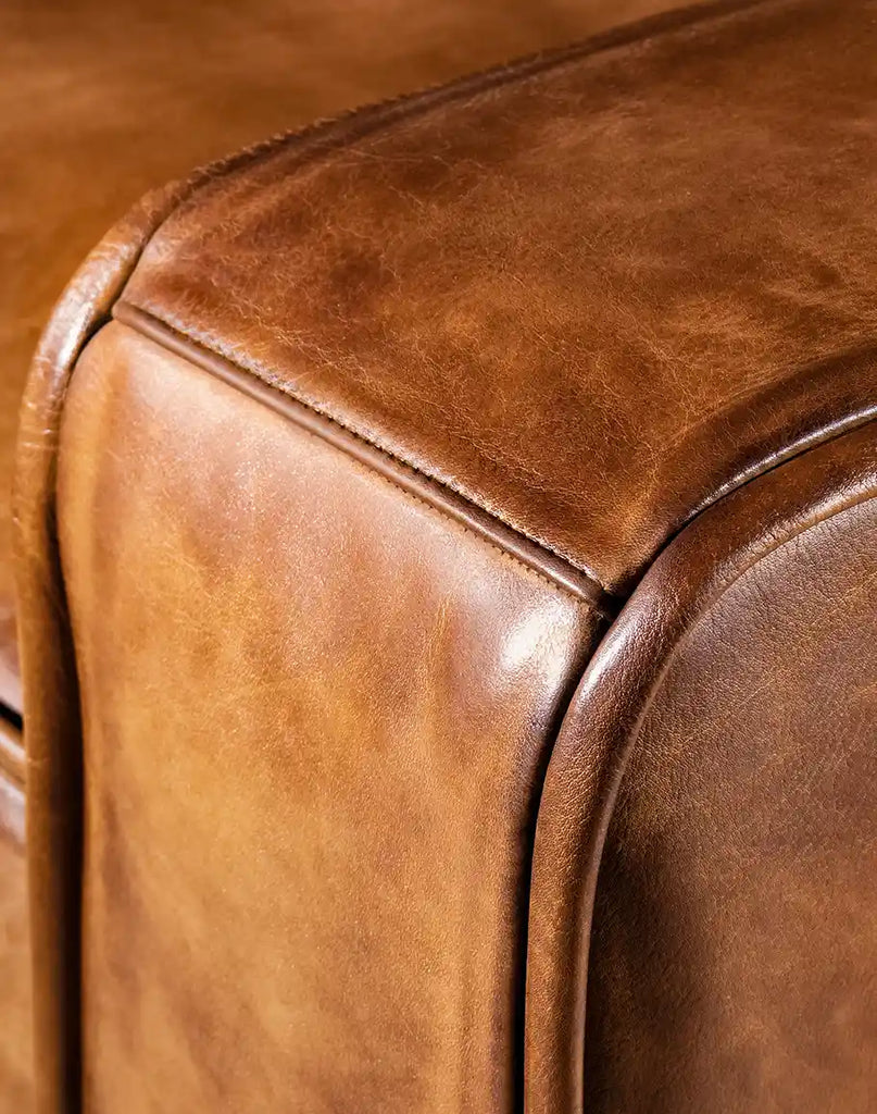 Close-up of the precise stitching and seamless tailoring on the Rusty Leather Chair, reflecting the artisanal care invested in every detail.