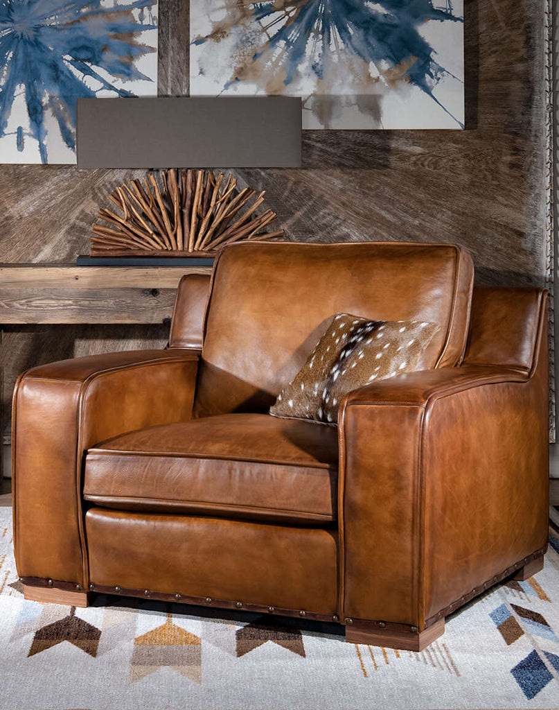 Rusty Leather Chair showcasing its signature hand-burnished leather upholstery and plush, padded seat for sublime comfort.