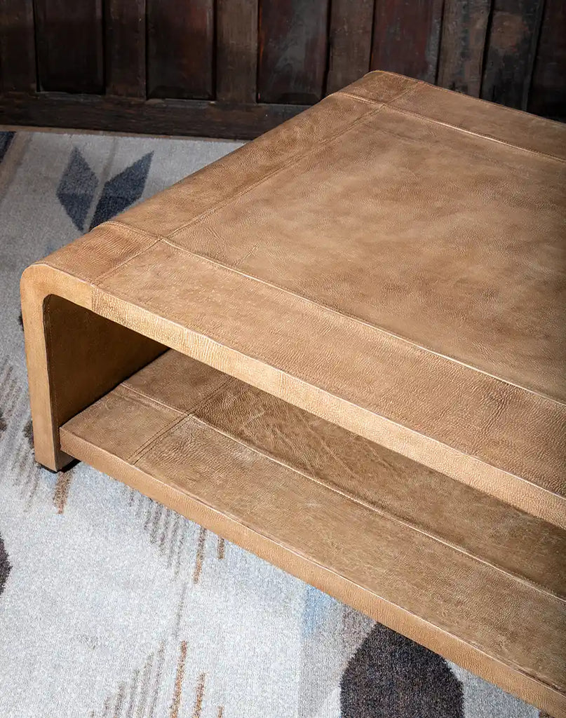 The open shelf on the Sahara Sand Leather Coffee Table, providing convenient storage for books, magazines, or decorative items.