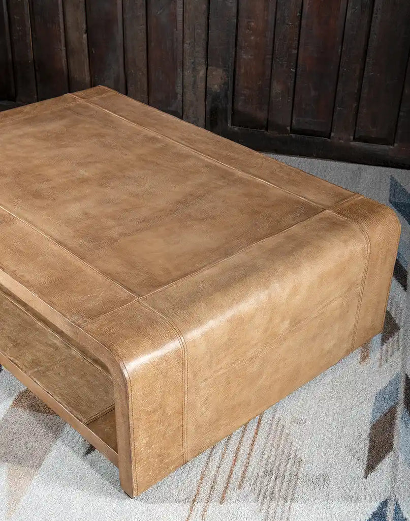 A side profile of the Sahara Sand Coffee Table, highlighting its sleek waterfall edge and elegant leather finish.