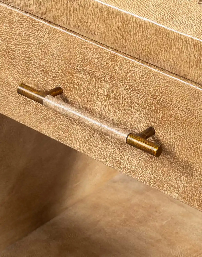 The Sahara Sand Leather Nightstand’s sturdy drawer, highlighted with a sleek brass pull handle for practical storage of bedside essentials.