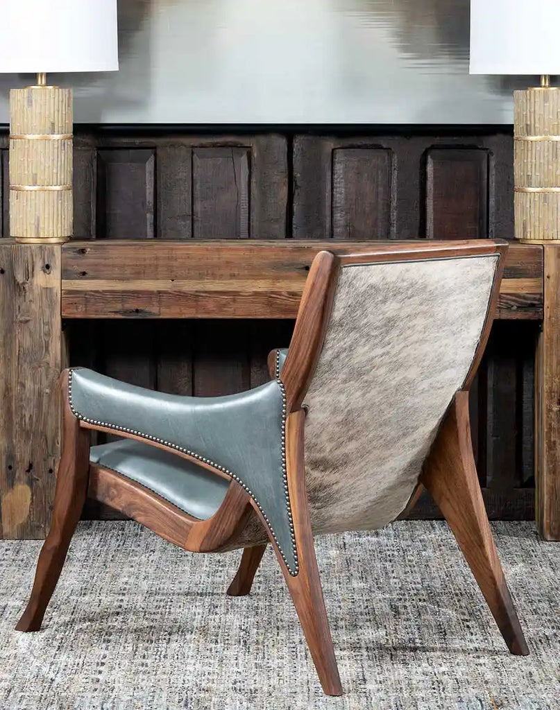 Angled rear view perspective highlighting the grey brindle cowhide accent on the chair’s external back.