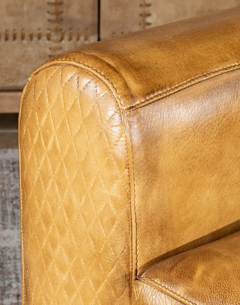 Detailed view of the armrest on the Sand Dune Leather Recliner, highlighting precise stitching and artisanal craftsmanship.