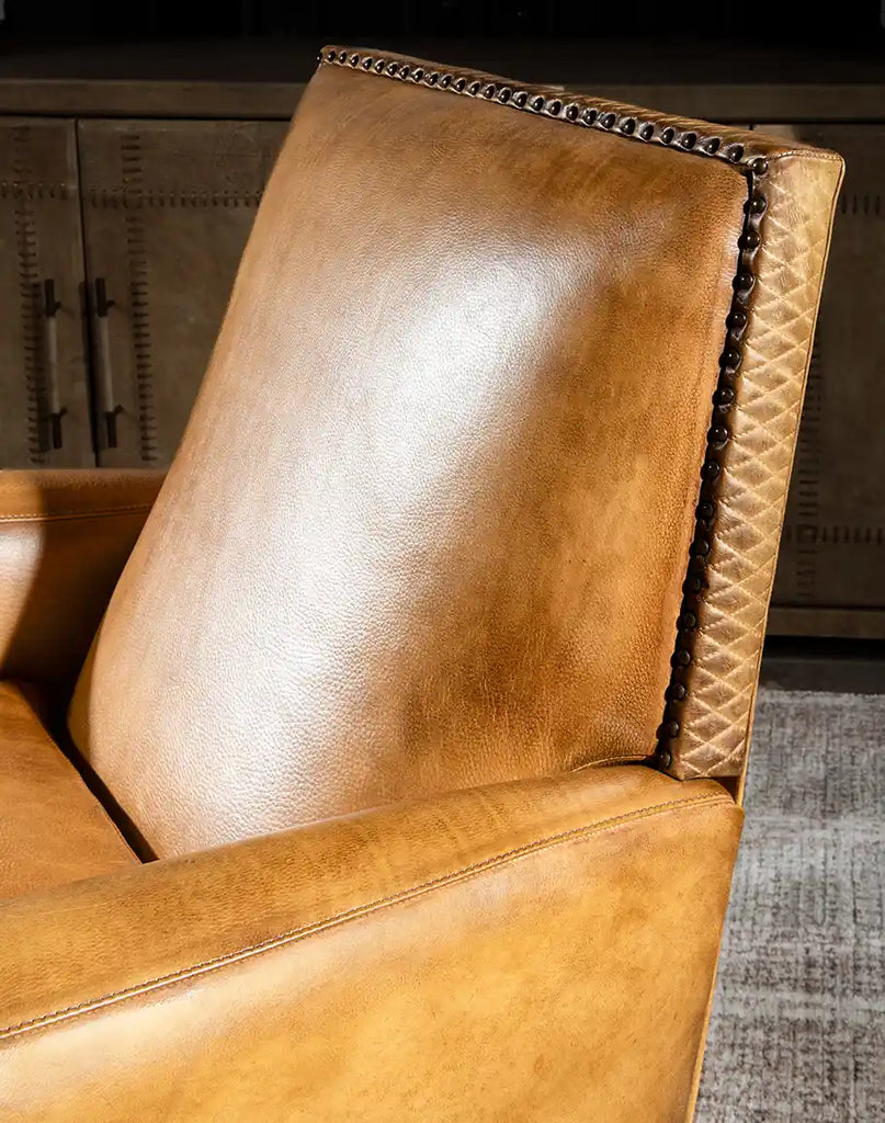 Close-up of the hand-burnished full-grain leather on the Sand Dune Leather Recliner, showcasing its natural variations and rich texture.