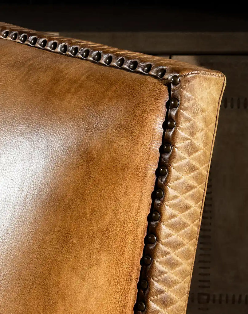 Close-up of the brass nailhead trim on the Sand Dune Leather Recliner, adding a sophisticated touch to its design.