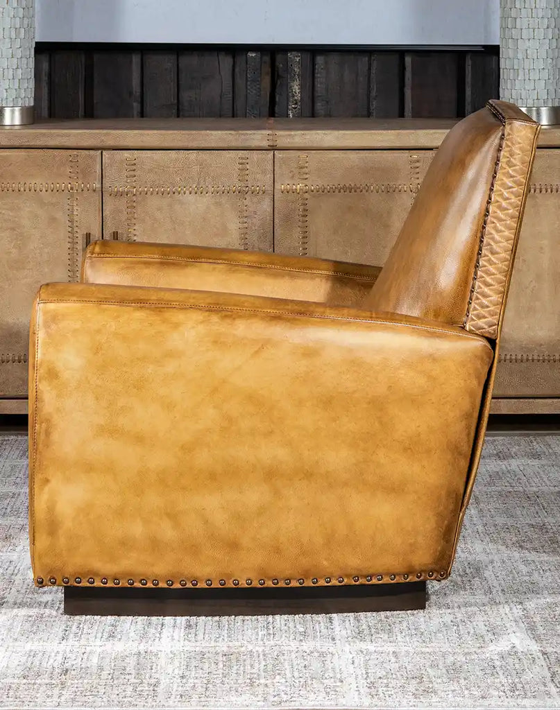 Side profile of the Sand Dune Leather Recliner emphasizing its cozy saddle tan hue and sleek silhouette.