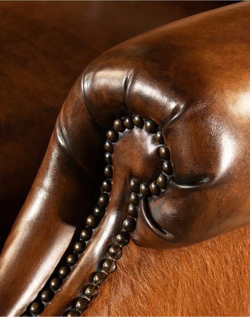 Detailed view of brass nail tacks along the edges of the Scottie Leather Recliner, highlighting its elegant craftsmanship.